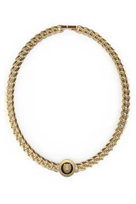 A gold chain necklace with a lion head pendant on a white background.