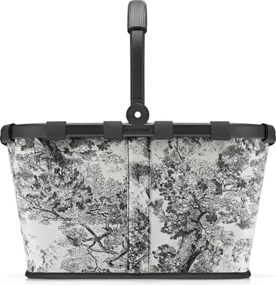 A shopping basket with a toile-like pattern.