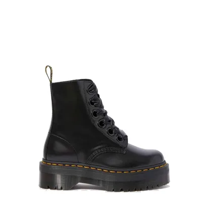 A black Dr. Martens platform lace-up boot is shown against a white background.