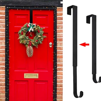 A red front door decorated with a Christmas wreath and lights, alongside a product image of two black wreath hangers.