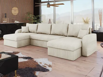 A U-shaped sectional sofa in a living room with a large window, a cowhide rug, and a modern coffee table.
