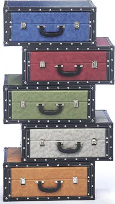 A stack of five decorative suitcases in different colors, arranged in a staggered formation.