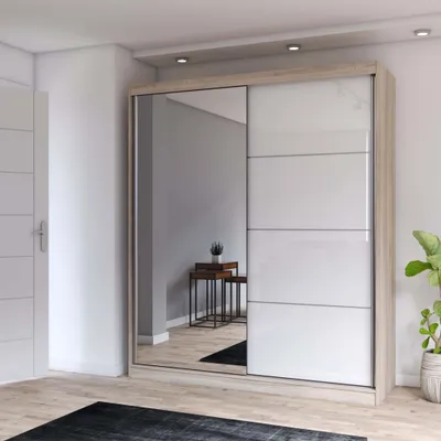 A modern sliding door wardrobe with a mirrored front panel and white doors, placed in a room with wooden flooring.