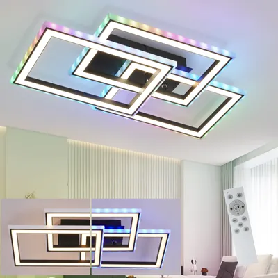 A modern, geometric LED ceiling light fixture with multiple interlocking rectangular frames, illuminated with colorful RGB lights and white light. A remote control is shown in the foreground.