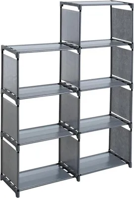 A gray fabric shelving unit with seven compartments arranged in a stepped pattern.