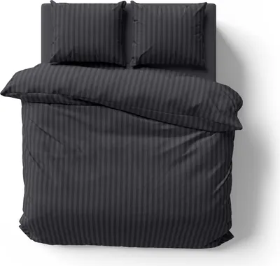 A top-down view of a black striped duvet and two pillowcases laid out on a bed.