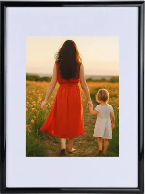 A woman and a child walking in a field of flowers.