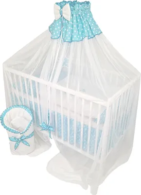 A baby crib with bedding and a canopy.