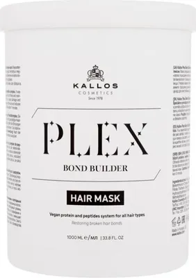 A white tub of hair mask with black text and branding.