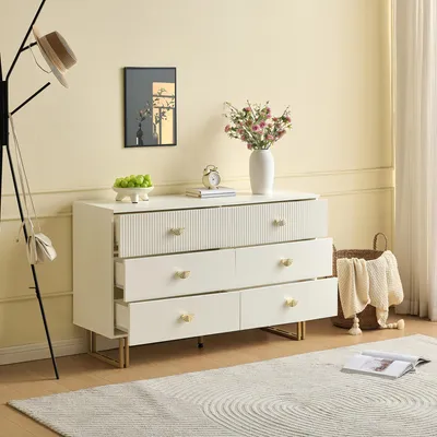 A white dresser with gold accents is shown in a room with a hat rack and a rug.