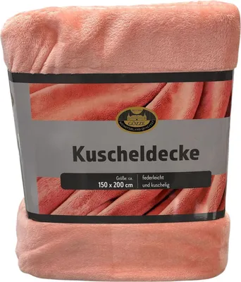 A pink blanket is folded and presented with its packaging.