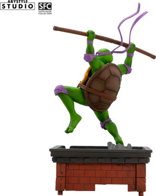 A statue of Donatello from Teenage Mutant Ninja Turtles on a brick platform.