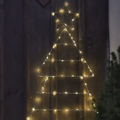 A string of lights in the shape of a Christmas tree with a star on top, mounted on a wooden wall.