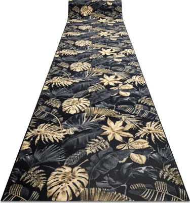 A long runner rug with a tropical leaf pattern is laid out on a white background.