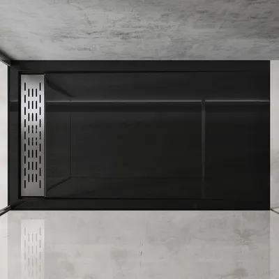 A top-down view of a modern, rectangular shower tray with a black surface and a silver drain.