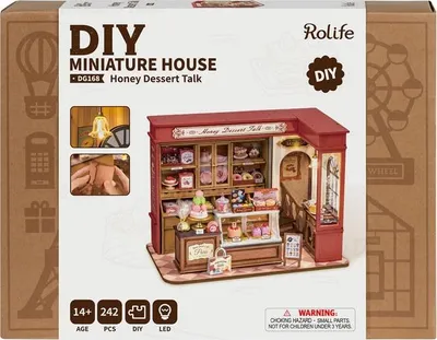 The image shows the packaging of a DIY miniature house kit, specifically a dessert shop model. The packaging displays the product name, brand, and a visual representation of the finished miniature house.