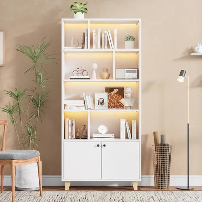 A white bookshelf with various items displayed on its shelves, including books, decorative objects, and a radio. The bookshelf has LED ambient lighting. A floor lamp and a chair are also visible in the scene.