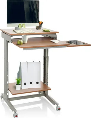 A mobile standing desk with a computer, keyboard, mouse, mug, apple, tablet, and files.