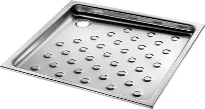 A stainless steel shower tray with a grid of circular indentations and a drain hole.