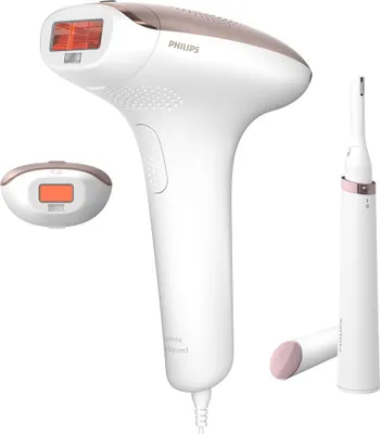 A white and rose gold Philips Lumea IPL hair removal device with accessories is displayed against a white background.