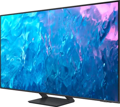 A Samsung television with a colorful abstract image displayed on its screen, shown from a side angle on a stand.