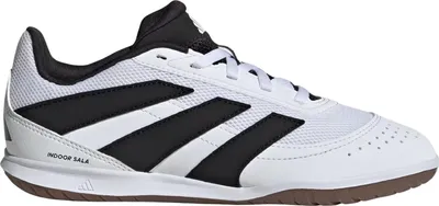 A side view of a white and black Adidas indoor soccer shoe.