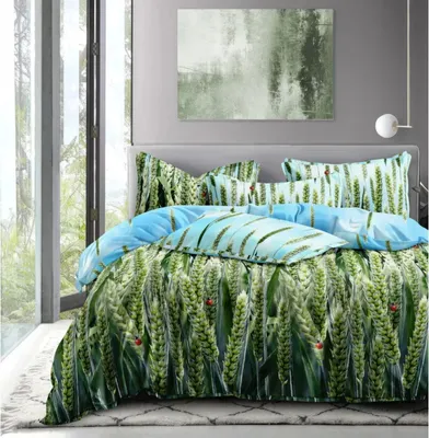 A bed with a green and blue patterned duvet cover and pillows, set in a room with a large window and abstract art on the wall.