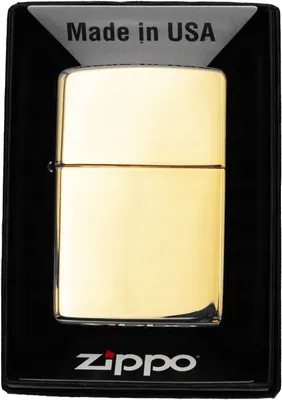 A gold Zippo lighter is displayed in its black packaging.