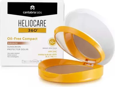 A compact powder foundation with SPF protection, shown open with its mirror, next to its packaging.