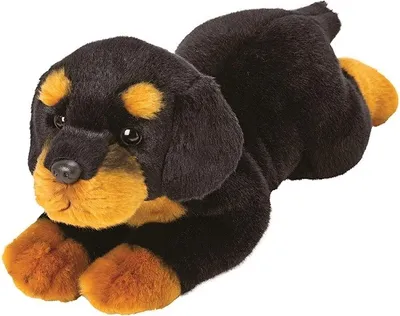 A plush toy dog lying down.