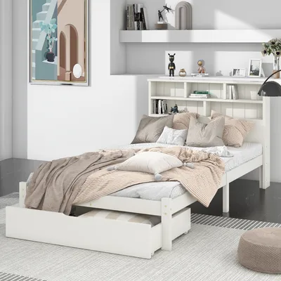 A bedroom scene with a white bed, bedding, and a bookshelf headboard.