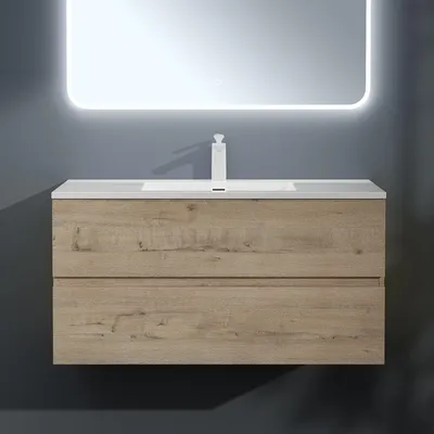A modern bathroom vanity with a sink and mirror.