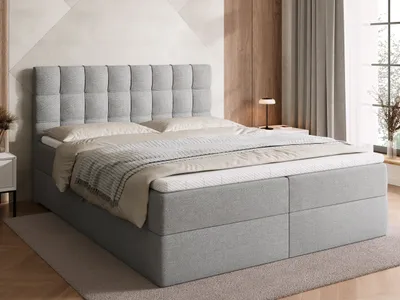 A bedroom scene featuring a bed with bedding.