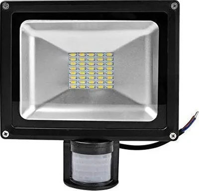 A black LED floodlight with a motion sensor attached.