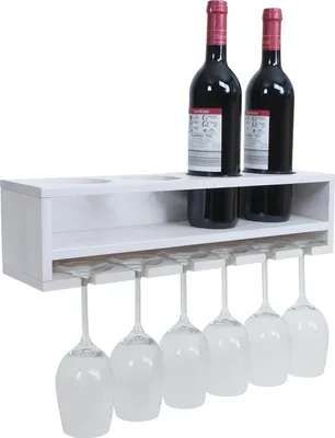 A white wooden wine rack mounted on a wall, holding two bottles of red wine and six wine glasses.