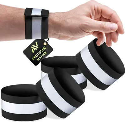 A hand wearing a reflective wristband, with several other reflective wristbands arranged in the foreground.