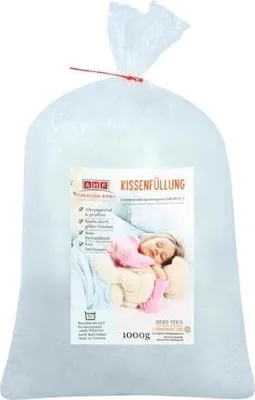 A large bag of white pillow filling with a label showing a sleeping child and product details.