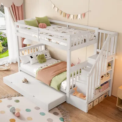 A white bunk bed with a pull-out trundle bed in a child's bedroom.
