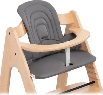 A close-up view of a grey padded seat cushion for a wooden highchair.