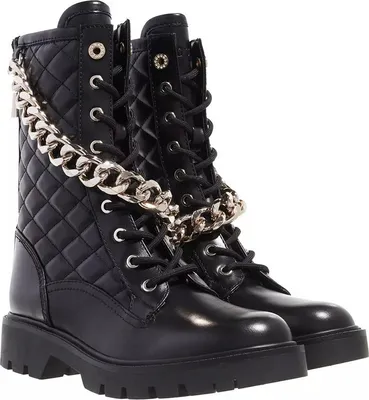 A pair of black quilted combat boots with a silver chain detail.