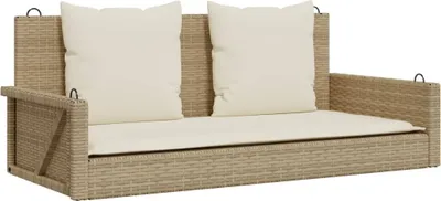 A beige rattan hanging bench with cream cushions, shown against a white background.
