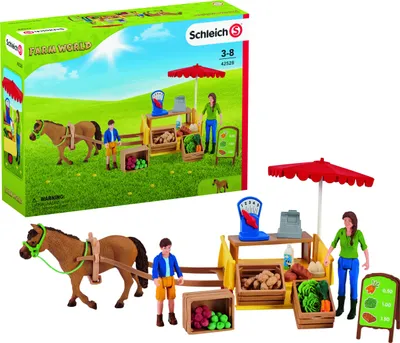 A toy farm stand playset with figures and accessories, shown both in its packaging and as a standalone display.