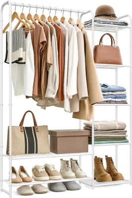 A white garment rack filled with clothing and accessories, with shelves holding folded clothes, bags, and shoes.
