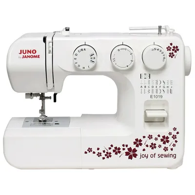 A white sewing machine with decorative maroon floral patterns and text.