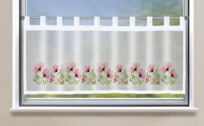 A sheer curtain with a floral pattern is hung on a window.