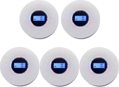 Five white, circular carbon monoxide and smoke detectors are arranged in a staggered pattern against a white background.