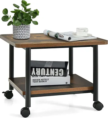 A small side table with a plant, a magazine, and a teacup on top, and books on the shelf below.