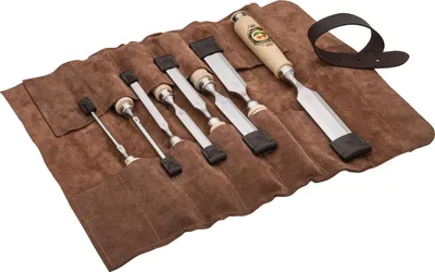 A set of chisels laid out in a brown leather roll-up case.