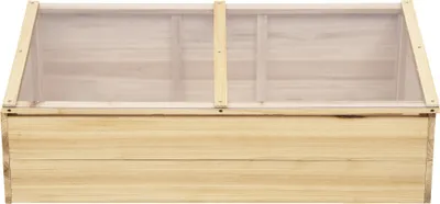 A wooden cold frame with a clear lid.
