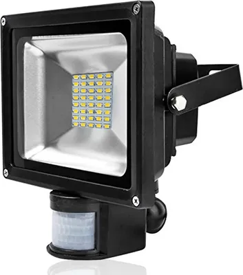 A black LED floodlight with a motion sensor is shown against a white background.